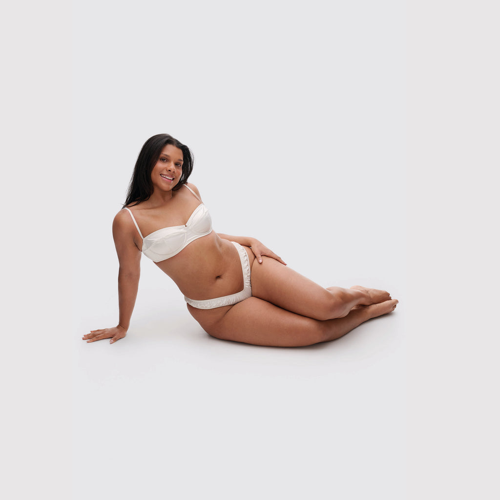 Ivory satin balconette bra on model