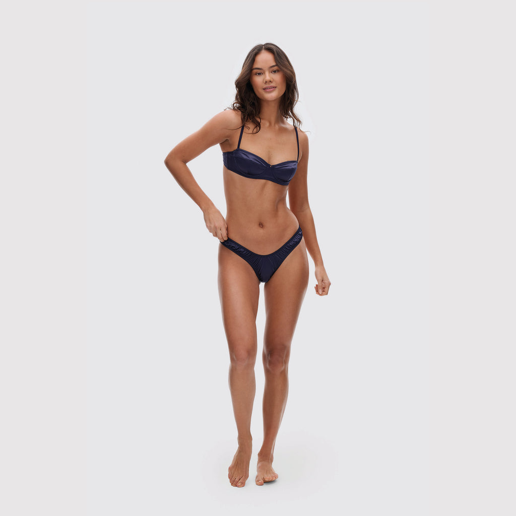 Navy V-shaped satin thong on model, full body view
