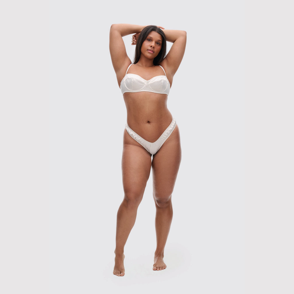 Ivory V-shaped satin thong on model, full body view